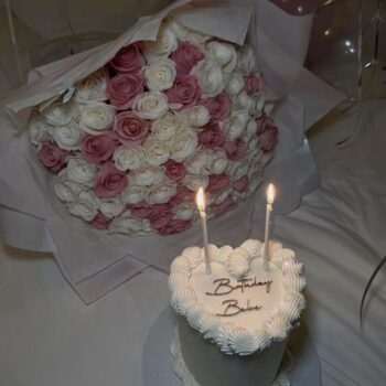 Send 8 inches heart shaped cake with 100 mixed roses